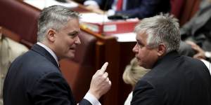 Minister for Finance Mathias Cormann in discussion with senator Rex Patrick in the Senate. 