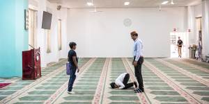 Ahmadiyya Muslim children prepare for prayer.