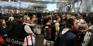A mass of passengers navigate confusing queues at Sydney Domestic Terminal 2 on Saturday.