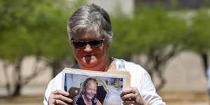Hilda Reckard,the daughter-in-law of victim Margie Reckard,holds a picture of her outside court.