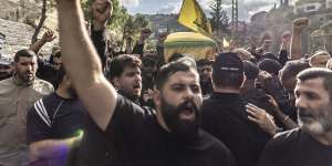 Hezbollah supporters chant slogans against US and Israel while carrying the coffin of a Hezbollah militant killed on Tuesday during clashes against IDF in the southern border of Lebanon.