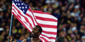 American Michael Johnson celebrates his victory in the men's 400m.