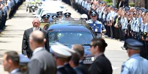 Constables Rachel McCrow and Matthew Arnold are given a guard of honour in Brisbane.