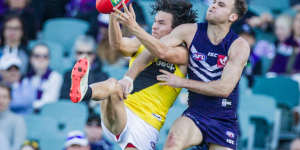 Fully committed:Richmond's Daniel Rioli holds strong as Hayden Crozier attempts a spoil.