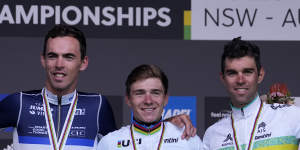 Australia’s Michael Matthews,right,Belgium’s Remco Evenepoel and Christophe Laporte,left,pose for a photo following the medal ceremony for the men’s elite road race at the world road cycling championships in Wollongong.