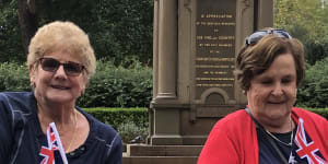 Merrilyn Taylor (red top) and Sylvia Campbell watching the Anzac Day march.