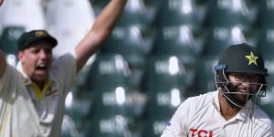 Pakistan’s Imam-ul-Haq,right,reacts while Australia’s Cameron Green celebrates his dismissal.