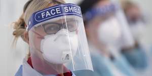 A medico wearing a face shield and mask for protection against the coronavirus.