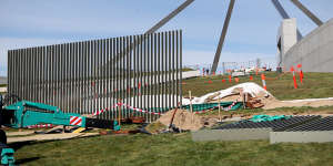 A security fence is installed across the lawns of Parliament House in Canberra.