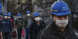 Construction workers finish their shift in Beijing.