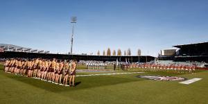 Hawthorn and Adelaide players line up during a ceremony ahead of Anzac Day before their clash at UTAS Stadium on Sunday.
