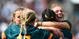 Grace Kemp and the Wallaroos celebrate victory over Wales at the World Cup.