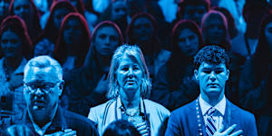 Standing for the national anthem at the AmericaFest convention.
