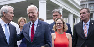 Not always all smiles:US President Joe Biden,centre,addresses a group of senators including Senator Kyrsten Sinema.