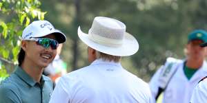 Greg Norman chats with fellow Australian Min Woo Lee at Augusta.