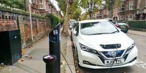 An electric car being charged on a residential street in London.