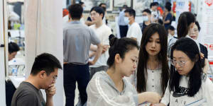 Young people attend a job fair at a Beijing shopping centre. Youth unemployment is at a high in China.
