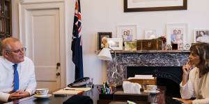 Morrison in his office with senior writer Deborah Snow and the eagle image,a divine signal,he says,he needed to persevere.