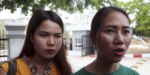 Pan Ei Mon,right,wife of Reuters journalist Wa Lone,talks to journalists as she leaves the Supreme Court along with Chit Su Win,left,wife of Reuters journalist Kyaw Soe Oo,on Tuesday.