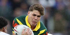 Reece Walsh is tackled by England’s Harry Smith and Kai Pearce-Paul.