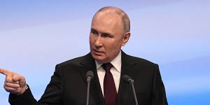 Russian President Vladimir Putin gestures while speaking on a visit to his campaign headquarters on Monday.