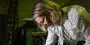 Sydney Morning Herald editor Jordan Baker looking at old editions in the Fairfax archives.