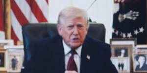 A person worships as a recorded video message from President Donald Trump plays at Rededicate 250.
