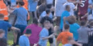 Fans invade pitch as City claim fourth-straight title