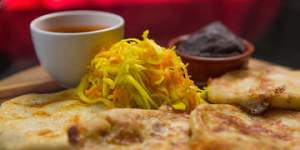 Pupusas with refried beans and pickled cabbage.