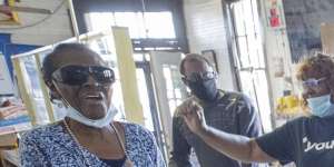 Gail Russell,68,falls to her knees and proclaims “Thank you,Jesus” at Gloria’s Corner Store in New Orleans,as she listens to the verdict on TV.