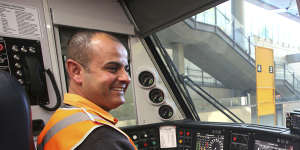 Train driver Adam Ghamrawi at the controls of a new Waratah train at Olympic Park.