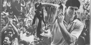 Stephen Kernahan,pictured holding the 1987 premiership cup,is happy to see Joel Selwood equal his record. 