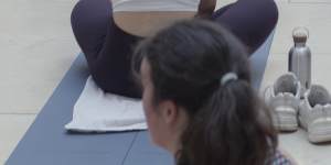 A yoga class,held before crowds arrive,in The Louvre Museum in Paris.