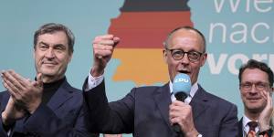 Friedrich Merz,front right,leader of the Christian Democratic Union,gestures while addressing supporters at the party headquarters in Berlin.