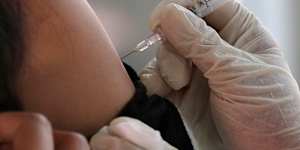 A passenger receives a shot of the Sinovac COVID-19 vaccine during a vaccination campaign at the Jakarta Kota train station in Jakarta,Indonesia,Wednesday,July 28,2021. (AP Photo/Tatan Syuflana)