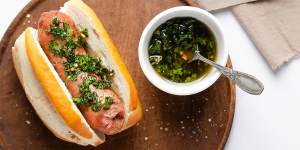 A choripan with chimichurri sauce.