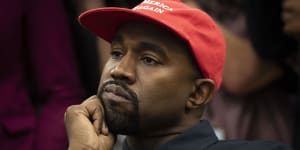 Rapper Kanye West,now known as Ye,listens during a meeting with then-President Donald Trump at the White House in October 2018. 