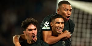 Achraf Hakimi (centre) celebrates with PSG’s other goalscorer,Kylian Mbappe (right) and Vitinha.