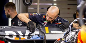 Red Bull Racing engineers work on the rear wing of Max Verstappen’s car to ensure it opens up to enable DRS,in Spain in 2022.