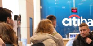 Russian customers queue at a Citibank ATM in Moscow to withdraw their cash. 