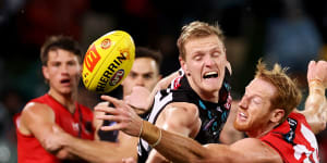 Sam Hayes of the Power competes with Essendon’s Andrew Phillips.