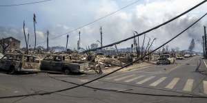 What appear to be power lines down at the scene at one of Maui’s tourist hubs which was reduced to wreckage by the fires.