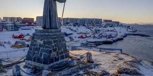 A statue commemorating Hans Egede,the Danish missionary who founded Nuuk in 1728,stands on a hill overlooking the town in Greenland.