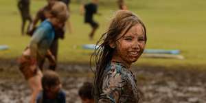 Lara Bowden,10,playing in the mud in the wake of ex-cyclone Alfred,at Skennars Head in northern NSW