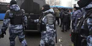 Riot police guards next to a van with the coffin of Russian opposition leader Alexei Navalny.