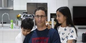 Kurt Bridde,44,with his children Izabelle,10,and Levi,7,in their Casula home.