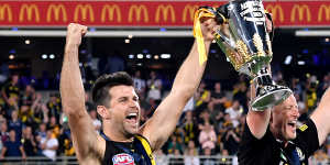 Trent Cotchin and Damien Hardwick lift the premiership cup.