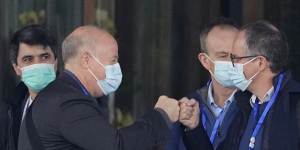 WHO investigator Peter Daszak,left,bumps fists with Peter Ben Embarek during their field visit in Wuhan.