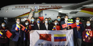 Venezuelan and Chinese officials repeat the PR exercise as a medical team arrives from China in La Guaira,Venezuela.