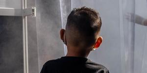 A child watches as people pass through a decontamination chamber at the La Vega Central fruit and vegetable market in Santiago,Chile,in 2020.